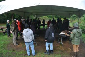 Gathering around the deer before beginning the butchering process